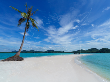 Leaning coconut palm on a white sand spit with turquoise sea, distant islands and a moored longtail boat