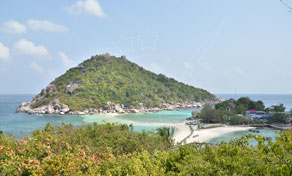 Viewpoint over a forested tropical island and white sandbar linking islets in turquoise sea, Thailand