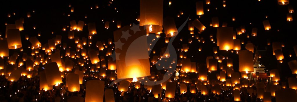 Thousands of glowing paper lanterns illuminating the night sky during a cultural festival celebration
