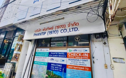 Phanfip Travel storefront with Thai signage, ferry booking office with colorful signs at street level.